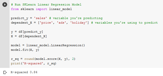 Python code that fits a scikit-learn LinearRegression on price, ads and holiday to predict sales, then prints an R-squared score of 0.84.